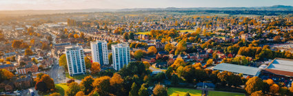 Aerial view of town with tower blocks and sports fields