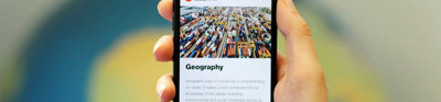 A smartphone screen displaying the Geography page of the Society's website.