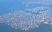 Aerial view of a peninsula with agricultural fields and scattered houses. 