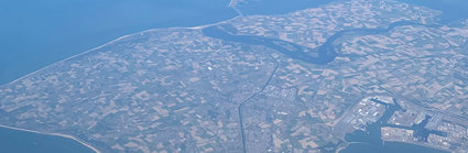 Aerial view of a peninsula with agricultural fields and scattered houses.