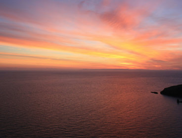 View across the calm sea at sunset from Lundy.