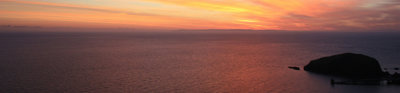 View across the calm sea at sunset from Lundy.