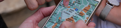 People holding a phone looking at a map