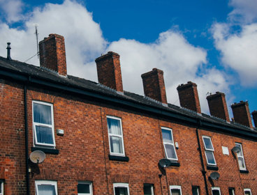 A row of identical red-bricked houses. 