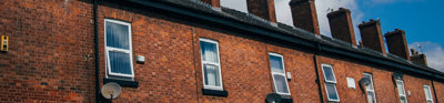 A row of identical red-bricked houses. 