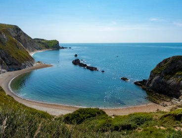 A view over Lulworth Cove in sunshine