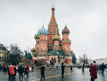 People walking on the street near Saint Basil's Cathedral. Church in Red Square in Moscow, Russia 