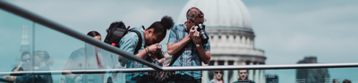 People taking photos on a bridge