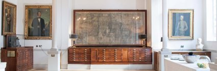 A large map mounted on the wall of the Map Room with a drinks catering station setup to the side.