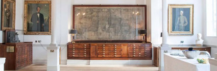 A large map mounted on the wall of the Map Room with a drinks catering station setup to the side.