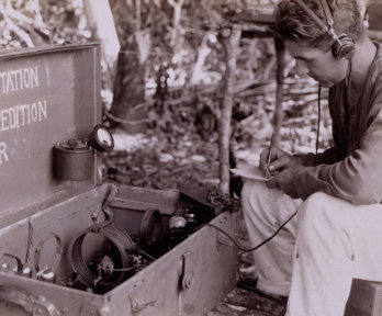 Person using radio equipment on Alexander Hamilton Rice’s final expedition to Amazonia.