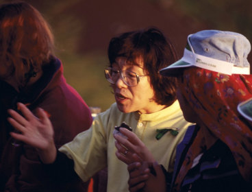 Junko Tabei in an engaged conversation with another person. 