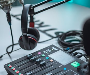 Mixing table, headphones and microphone in a recording studio 